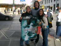 James Ritzman giving out a poster to a couple girls while promoting 'The Butterfly Effect'.