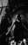 thumbnail black & white photo of a girl looking down while posing near industrial machinery as shot by James Ritzman