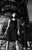 thumbnail black & white photo of a girl looking up while standing near industrial machinery as shot by James Ritzman