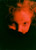 thumbnail closeup of a girl wearing a black shirt under a red light