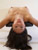 thumbnail of a naked girl laying draped over a low support pedestal