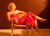 thumbnail of a blonde girl in a red dress sitting across a chair