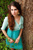 carly in blue-green dress